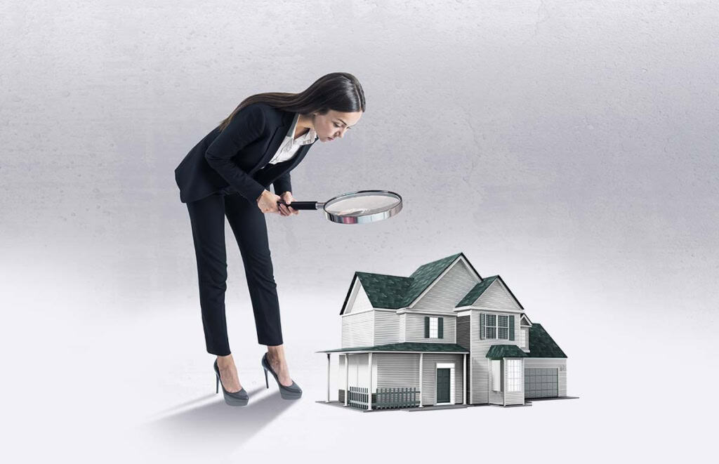 An agent inspecting a model house with a magnifying glass, on the truth about paid real estate leads